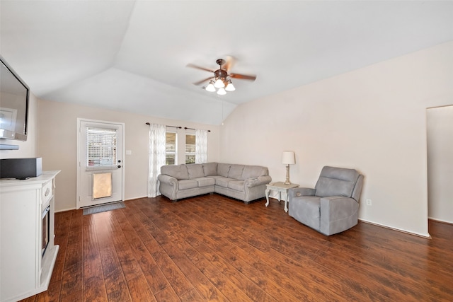 unfurnished living room featuring vaulted ceiling, dark hardwood / wood-style floors, and ceiling fan