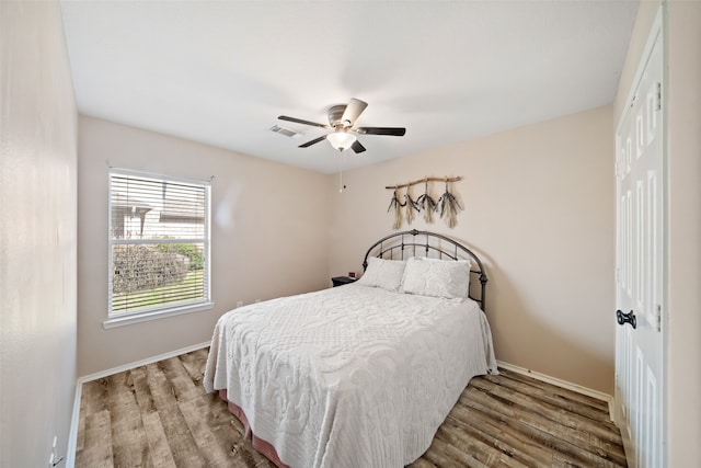 bedroom featuring hardwood / wood-style flooring, ceiling fan, and a closet