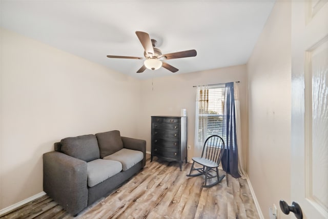 living area featuring ceiling fan and light hardwood / wood-style floors