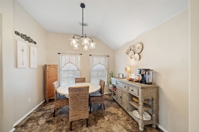 dining area featuring lofted ceiling and a chandelier