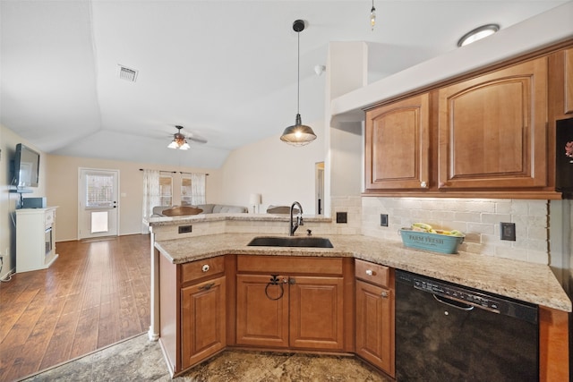 kitchen with sink, dishwasher, backsplash, decorative light fixtures, and vaulted ceiling