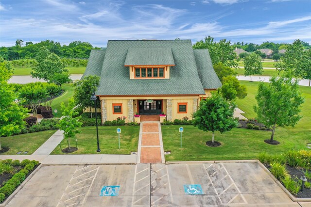 4423 Southpoint Way, Fulshear, TX 77441 - view of front facade featuring stone siding, uncovered parking, and a front yard