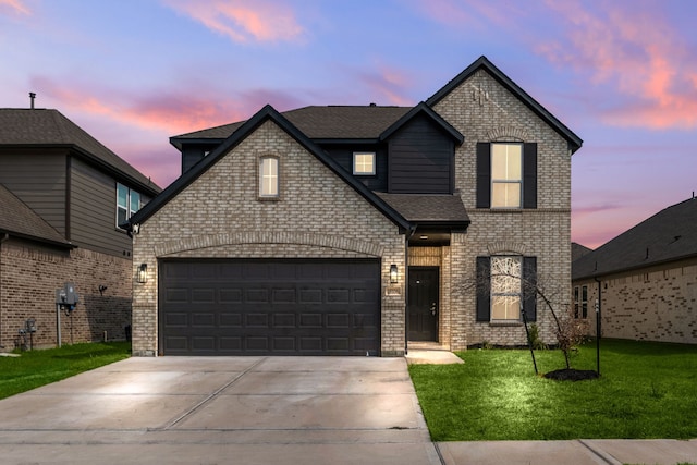 view of front of house with a garage and a lawn