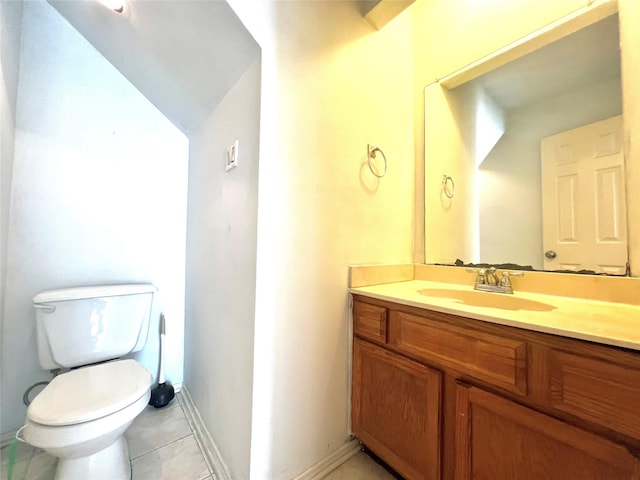 bathroom with tile patterned flooring, vanity, and toilet