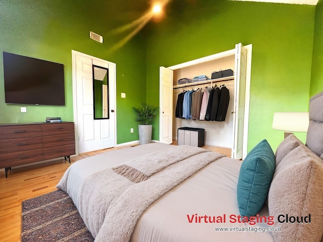 bedroom with wood-type flooring and a closet