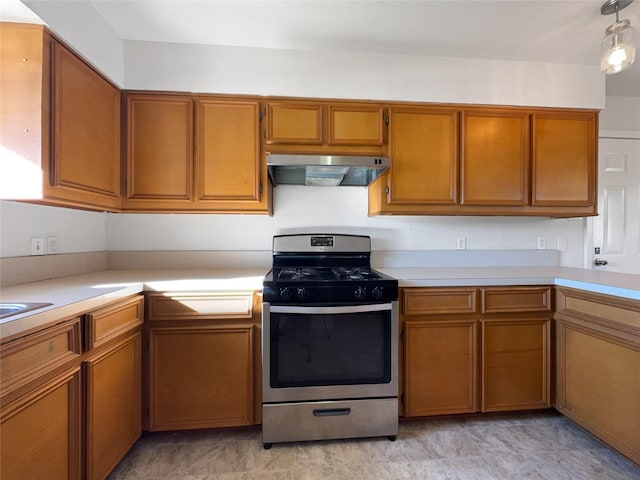 kitchen featuring gas range, extractor fan, and decorative light fixtures