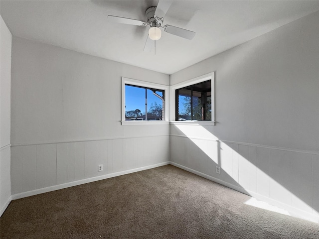 unfurnished room with ceiling fan and carpet floors