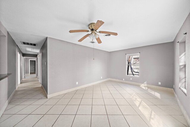 spare room with light tile patterned floors and ceiling fan