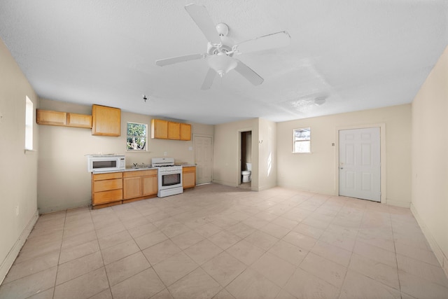 kitchen featuring white appliances and ceiling fan