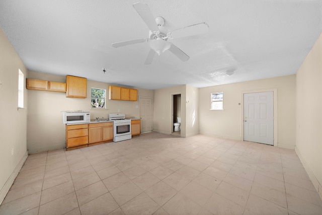 128 Kress St, Houston, TX 77020 - kitchen featuring white appliances, light countertops, a ceiling fan, and baseboards
