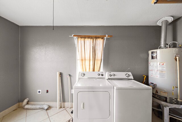 laundry room featuring independent washer and dryer, light tile patterned floors, and water heater