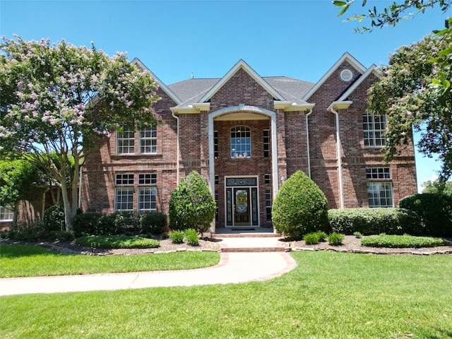 front facade with a front yard