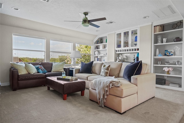 living room featuring light carpet, ceiling fan, lofted ceiling, and a textured ceiling