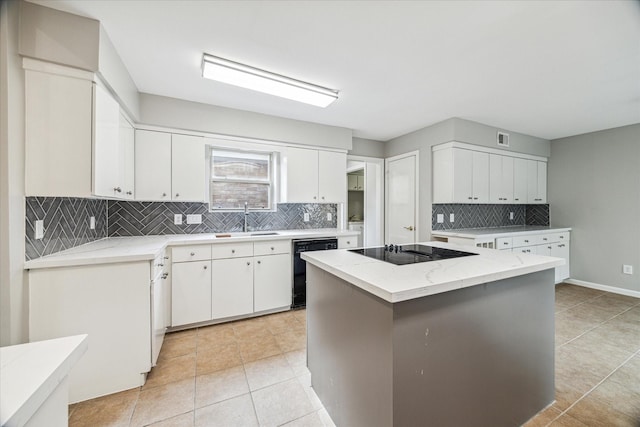 kitchen with sink, white cabinetry, a kitchen island, black appliances, and light tile patterned flooring