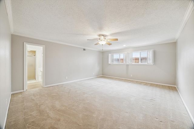 unfurnished room with light colored carpet, ornamental molding, ceiling fan, and a textured ceiling