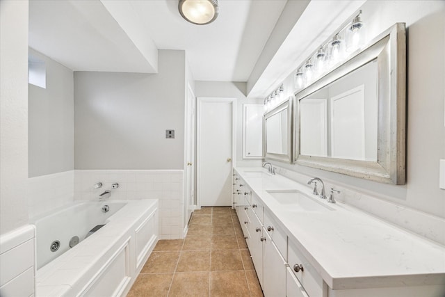 bathroom with vanity, tile patterned flooring, tile walls, and a bathtub