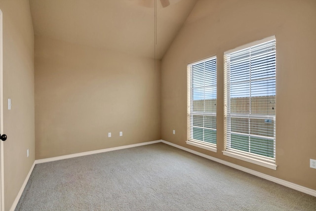 carpeted empty room featuring lofted ceiling