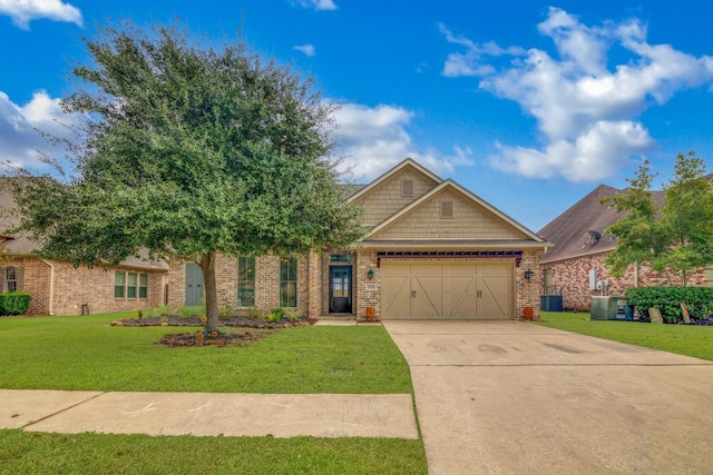 view of front of house featuring a garage, a front yard, and central air condition unit