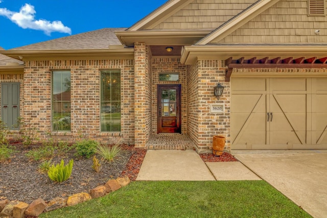 view of exterior entry with a garage