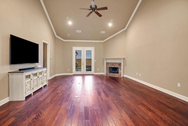 unfurnished living room with french doors, ceiling fan, a high end fireplace, and hardwood / wood-style floors