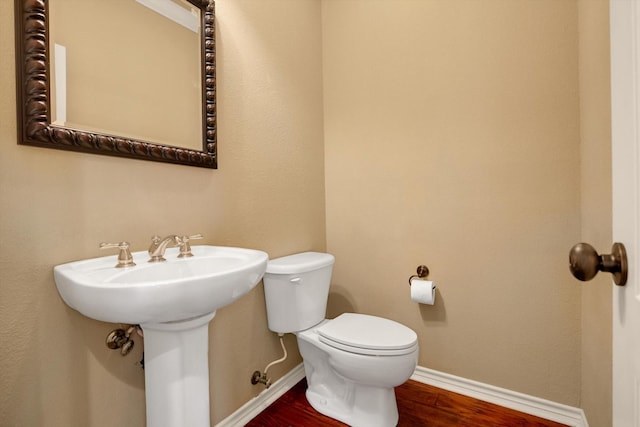 bathroom featuring toilet and hardwood / wood-style floors