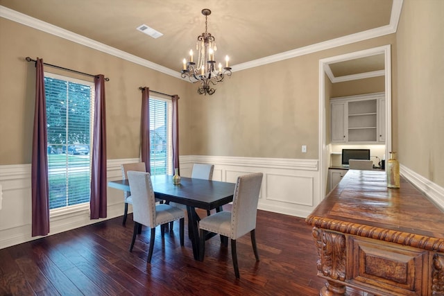 dining space with crown molding, dark wood-type flooring, and a notable chandelier