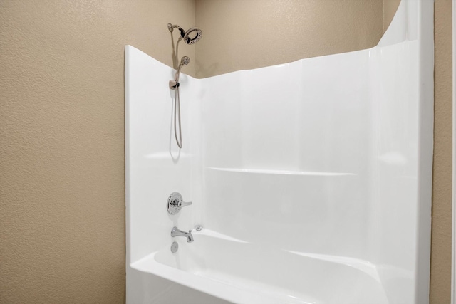 bathroom with bathing tub / shower combination