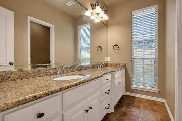 bathroom with vanity and a wealth of natural light