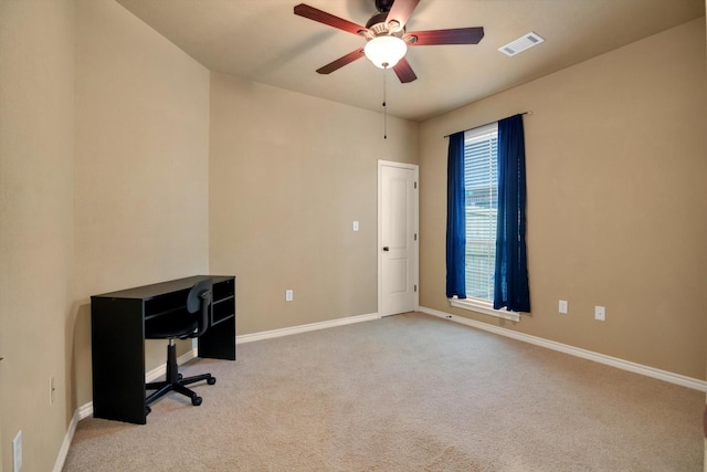 unfurnished office featuring light carpet and ceiling fan