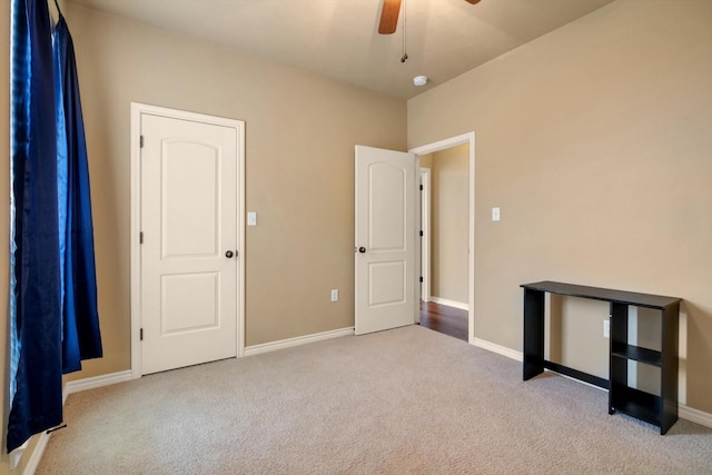 interior space with light colored carpet and ceiling fan