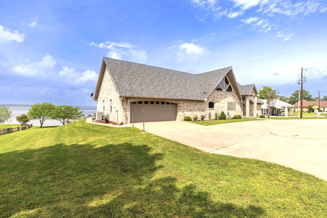 view of front of property featuring central AC, a garage, and a front lawn