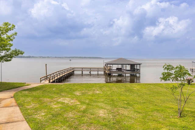 view of dock featuring a water view and a lawn