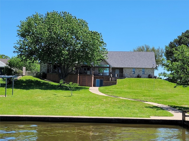 exterior space featuring a water view and a yard