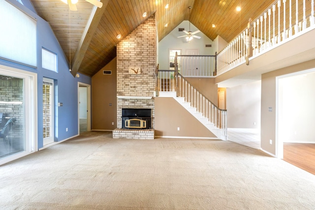 unfurnished living room with ceiling fan, a fireplace, and high vaulted ceiling