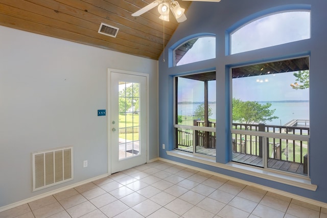 entryway with a water view, light tile patterned floors, vaulted ceiling, and wooden ceiling