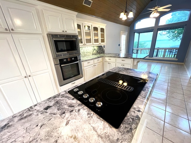 kitchen with backsplash, wood ceiling, stainless steel appliances, and white cabinets