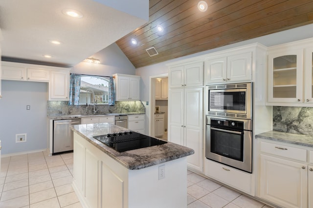 kitchen with wood ceiling, stainless steel appliances, a center island, white cabinets, and decorative backsplash