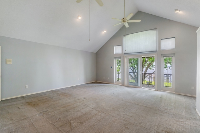 unfurnished living room featuring light carpet, high vaulted ceiling, and ceiling fan