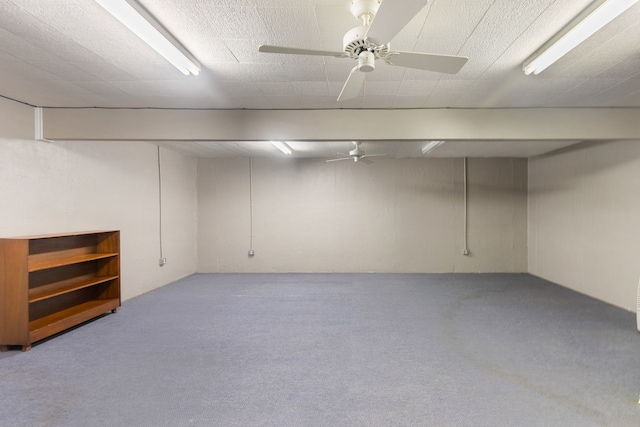 basement featuring light carpet and ceiling fan