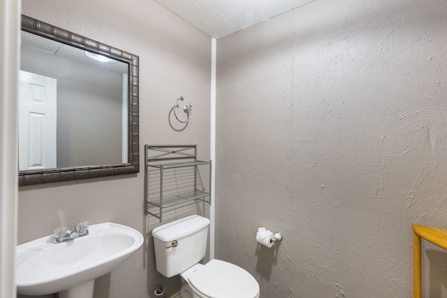 bathroom featuring sink and toilet