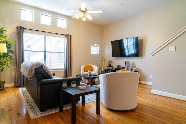 living room with ceiling fan and light hardwood / wood-style flooring