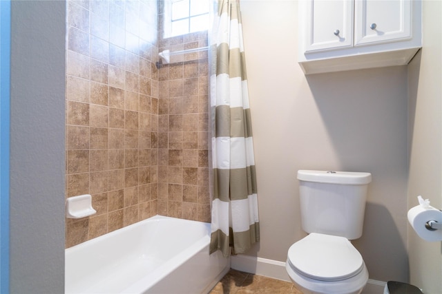 bathroom featuring shower / bath combination with curtain and toilet