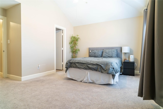 bedroom with light colored carpet and high vaulted ceiling