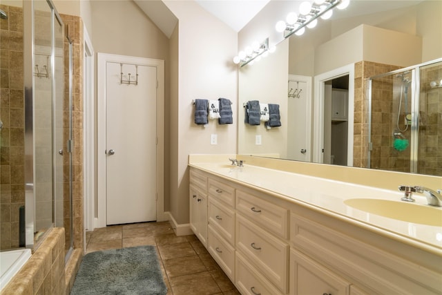 bathroom featuring tile patterned floors, vanity, and a shower with door