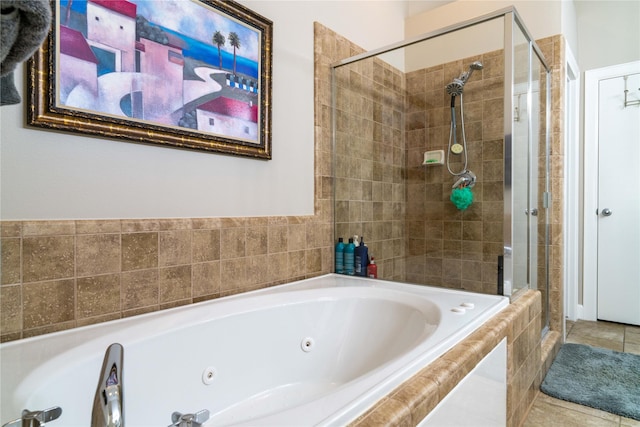 bathroom featuring tile patterned floors and independent shower and bath