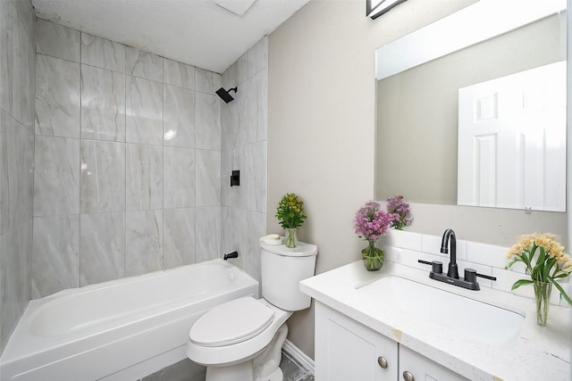 full bathroom featuring vanity, tiled shower / bath, and toilet