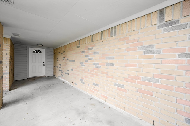 exterior space featuring brick wall