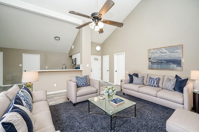 living room with hardwood / wood-style floors, high vaulted ceiling, sink, and ceiling fan