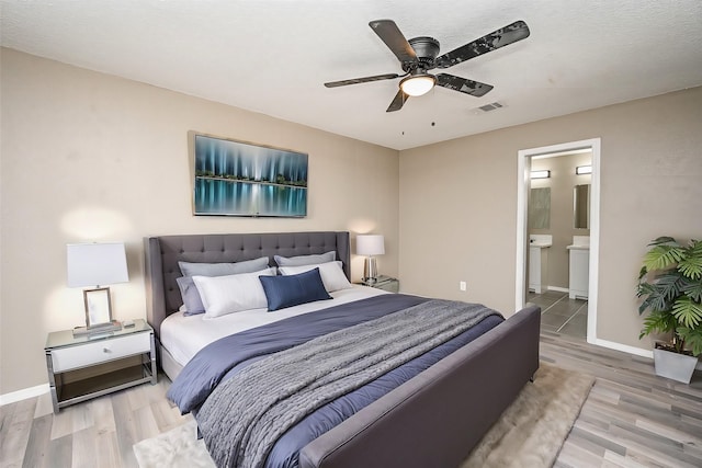 bedroom featuring ceiling fan, connected bathroom, and light wood-type flooring