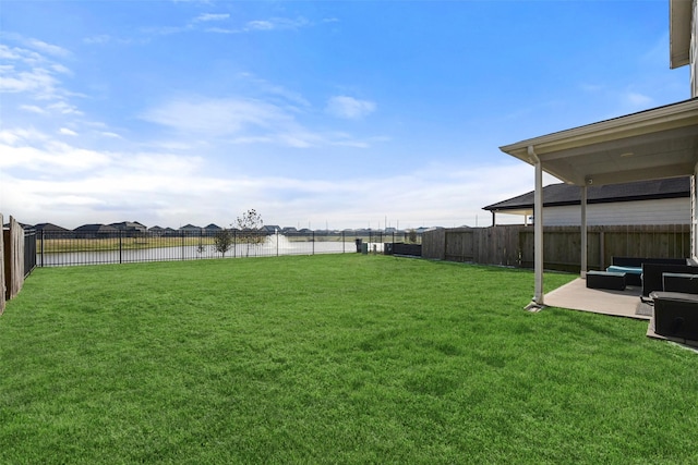 view of yard featuring a water view, outdoor lounge area, and a patio